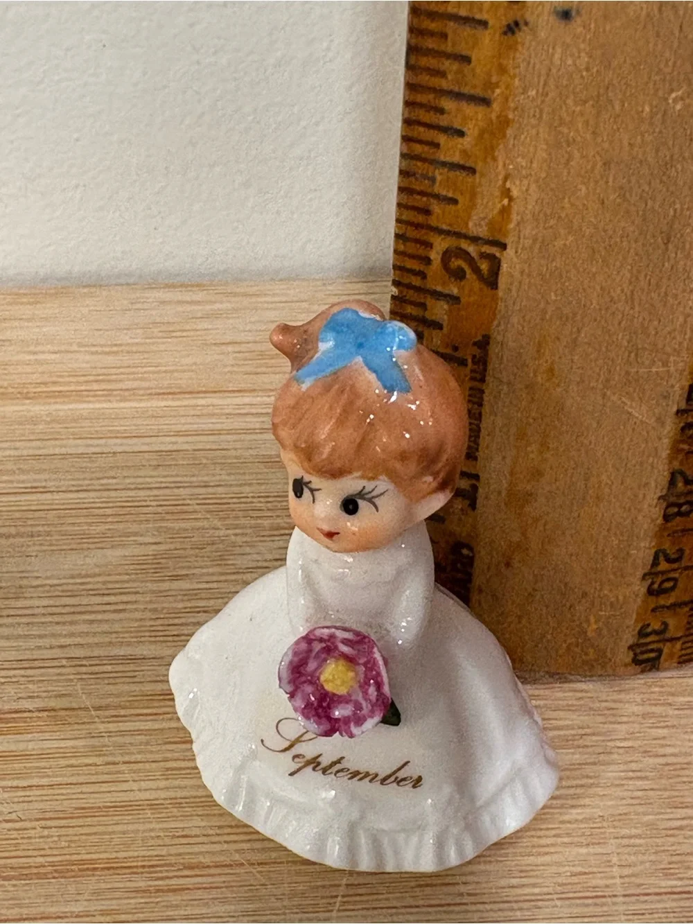 Napcoware September Ceramic Birthday Girl Figurine with Blue Bow and Pink Flower